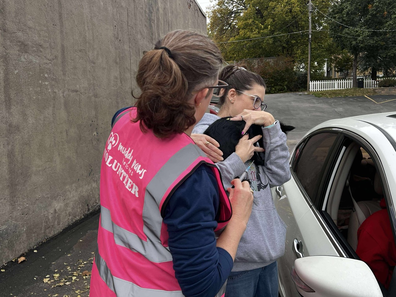 Shawna Anderson holding a puppy during a local volunteer event